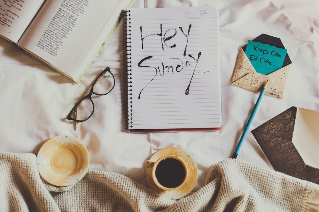 Open notebook with handwritten notes and a pen